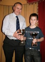 Adrian [Budder] McKay tries to gets his hands on a trophy won by his son John.