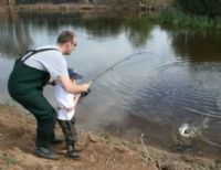 Peter Walls helps his son Ronan land a trout at the Open Day