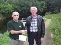 Tommy McGrath competition secretary of Moyola Angling Association presents a cheque for �1240 to John Barry of Cancer  Research UK Castledawson branch