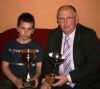 Young John McKay receives his award from Philip Maguire.